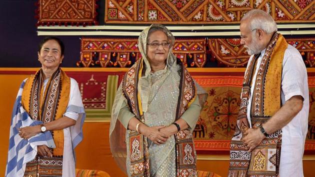 Prime Minister Narendra Modi speaks with his Bangladeshi counterpart Sheikh Hasina as West Bengal chief minister Mamata Banerjee looks on, during the annual convocation of Visva Bharati University, in Birbhum, on May 25. (PTI Photo) Prime Minister Narendra Modi speaks with his Bangladeshi counterpart Sheikh Hasina as West Bengal chief minister Mamata Banerjee looks on, during the annual convocation of Visva Bharati University, in Birbhum, on May 25. (PTI Photo)