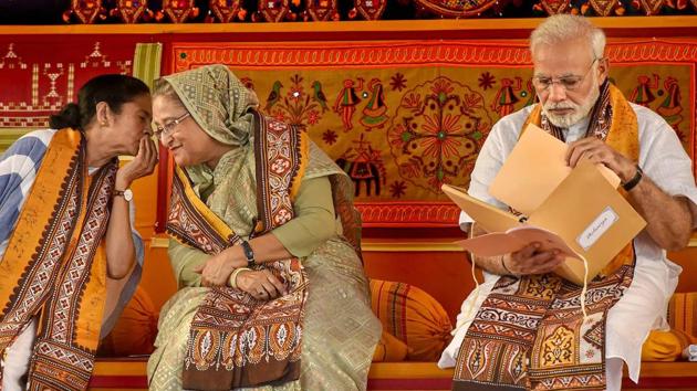 Prime Minister Narendra Modi with his Bangladeshi counterpart Sheikh Hasina and West Bengal chief minister Mamata Banerjee during the annual convocation of Visva Bharati University in Birbhum. Modi said he was sorry to know about the non-availability of drinking water in Santiniketan. Later during his speech Modi urged the students to turn 100 villages around the area self-sufficient to mark the central university’s centenary in 2021. (Ashok Bhaumik / PTI) Prime Minister Narendra Modi with his Bangladeshi counterpart Sheikh Hasina and West Bengal chief minister Mamata Banerjee during the annual convocation of Visva Bharati University in Birbhum. Modi said he was sorry to know about the non-availability of drinking water in Santiniketan. Later during his speech Modi urged the students to turn 100 villages around the area self-sufficient to mark the central university’s centenary in 2021. (Ashok Bhaumik / PTI)
