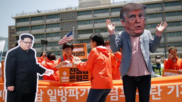 A man wearing a mask of US President Donald Trump performs next to a cutout of North Korean leader Kim Jong Un during an anti-US President Donald Trump rally near US embassy in Seoul, South Korea, on May 25, 2018. (Reuters) A man wearing a mask of US President Donald Trump performs next to a cutout of North Korean leader Kim Jong Un during an anti-US President Donald Trump rally near US embassy in Seoul, South Korea, on May 25, 2018. (Reuters)
