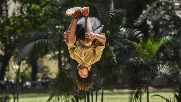 Birbal Dhanik, a young dancer is caught mid-air, practising a dance move at Five Gardens in Matunga of Mumbai, Maharashtra on May 21, 2018. (Kunal Patil / HT Photo)
