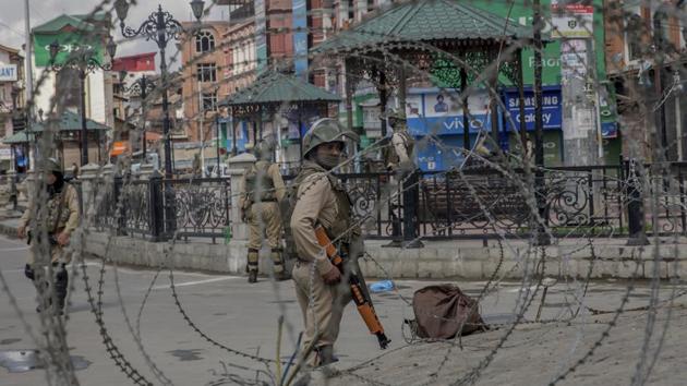 Paramilitary soldiers are seen through barbed wire in Kashmir (AP File Photo) Paramilitary soldiers are seen through barbed wire in Kashmir (AP File Photo)