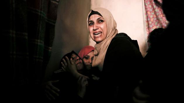 Relatives mourn Palestinian Moein Al-Saai who died of wounds he sustained protesting at the Israeli-Gaza border, during his funeral in Gaza city. (Mahmud Hams / AFP)