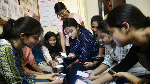 Students check their marks on mobile phones, after the declaration of Central Board of Secondary Education (CBSE)'s class 12th results, in Patna on Saturday. (PTI) Students check their marks on mobile phones, after the declaration of Central Board of Secondary Education (CBSE)'s class 12th results, in Patna on Saturday. (PTI)