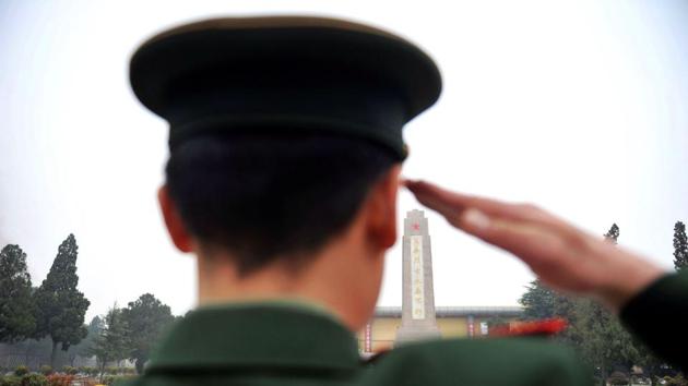 A paramilitary police officer salutes during a ceremony in China's eastern Shandong province.(AFP File Photo)