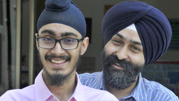 Agam, a student of DAV Public School, BRS Nagar, celebrating his success with his father in Ludhiana on Saturday. (Gurminder Singh/HT) Agam, a student of DAV Public School, BRS Nagar, celebrating his success with his father in Ludhiana on Saturday. (Gurminder Singh/HT)