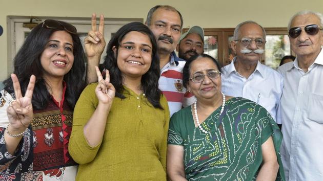 Astha Bamba of BCM Arya Model School Shastri Nagar along with her parents showing the victory sign after she scored 497 marks in humanities stream and joint third topper in India in CBSE class 12th result , in Ludhiana on Saturday. (HT Photo) Astha Bamba of BCM Arya Model School Shastri Nagar along with her parents showing the victory sign after she scored 497 marks in humanities stream and joint third topper in India in CBSE class 12th result , in Ludhiana on Saturday. (HT Photo)