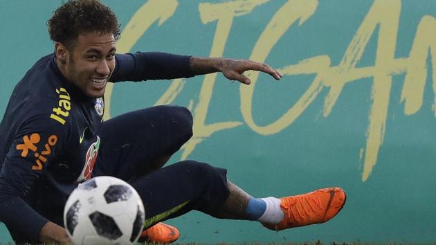 Brazil's Neymar smiles after taking a spill on the pitch during a national football team practice session ahead the World Cup in Russia, at the Granja Comary training center In Teresopolis. (AP) Brazil's Neymar smiles after taking a spill on the pitch during a national football team practice session ahead the World Cup in Russia, at the Granja Comary training center In Teresopolis. (AP)