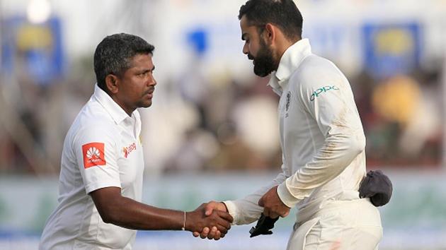 Indian cricket captain Virat Kohli (R) shakes hands with Sri Lanka captain Rangana Herath after the visitors won by 304 runs on Day 4 of the Test at the Galle cricket stadium July 29, 2017.(Getty Images)