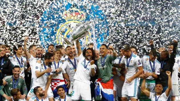 Real Madrid celebrate winning the Champions League with the trophy. (REUTERS) Real Madrid celebrate winning the Champions League with the trophy. (REUTERS)