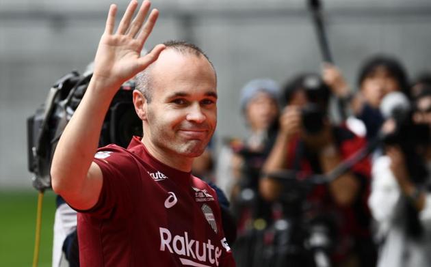 Spanish midfielder Andres Iniesta greets fans from the pitch of Noevir Stadium in Kobe on Saturday.(AFP)