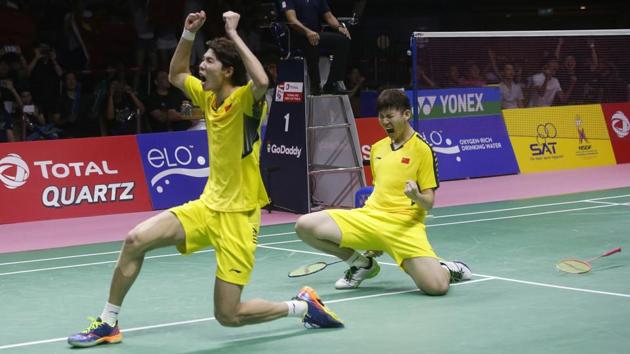 China's Li Junhui (L) and Liu Yuchen (R) react after winning their Thomas Cup finals badminton match at the Thomas and Uber Cup 2018 in Bangkok, Thailand on May 27, 2018.(AP)