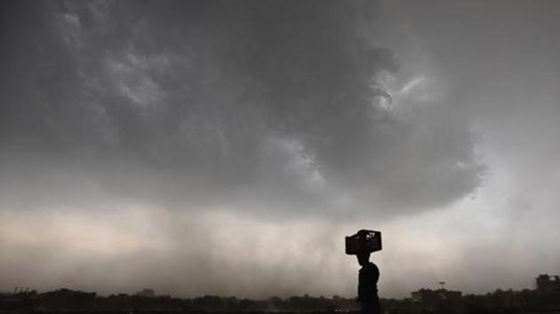 After a day of heat and humidity, weather took a sudden turn when thunderstorm and rain hit Gurgaon, and dark clouds enveloped the city on May 13. (Sanjeev Verma/HT Photo) After a day of heat and humidity, weather took a sudden turn when thunderstorm and rain hit Gurgaon, and dark clouds enveloped the city on May 13. (Sanjeev Verma/HT Photo)