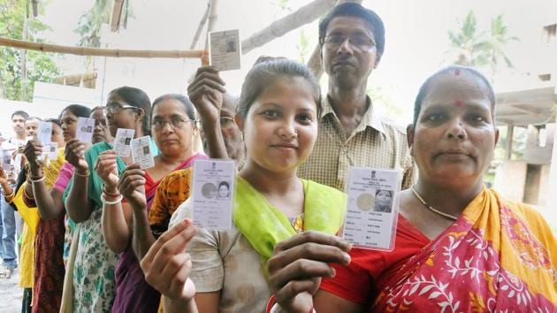 Voters show their Election Commission cards as they queue to cast their vote at a polling station during Maheshtala ssembly by-election, at Maheshtala in South 24 Parganas district of West Bengal, on Monday. (PTI Photo) Voters show their Election Commission cards as they queue to cast their vote at a polling station during Maheshtala ssembly by-election, at Maheshtala in South 24 Parganas district of West Bengal, on Monday. (PTI Photo)