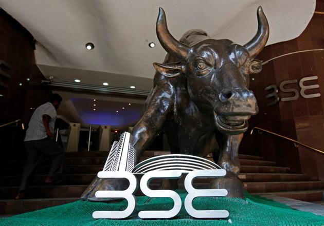 The Bombay Stock Exchange (BSE) logo is seen under a bull statue at the entrance of their building in Mumbai.(REUTERS File Photo)