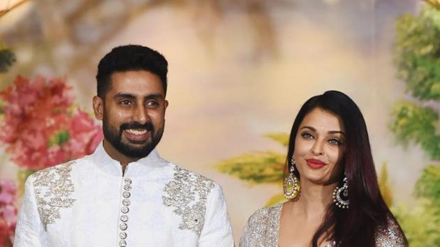 Abhishek Bachchan with his wife Aishwarya Rai Bachchan pose for a picture during the wedding reception of Sonam Kapoor and businessman Anand Ahuja.(AFP)