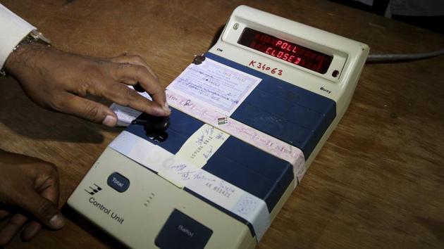 An election officer closes an electronic voting machine at the end of polls at a polling station in Bangalore on May 12, 2018.(AP Photo)