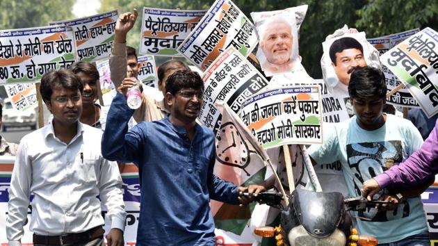 Delhi State Nationalist Youth Congress activists carry an effigy of Prime Minister Narendra Modi on a bike during a demonstration against Modi government to protest against the fuel hike and other issues near Shastri Bhawan in New Delhi. (Sonu Mehta / HT Photo) Delhi State Nationalist Youth Congress activists carry an effigy of Prime Minister Narendra Modi on a bike during a demonstration against Modi government to protest against the fuel hike and other issues near Shastri Bhawan in New Delhi. (Sonu Mehta / HT Photo)