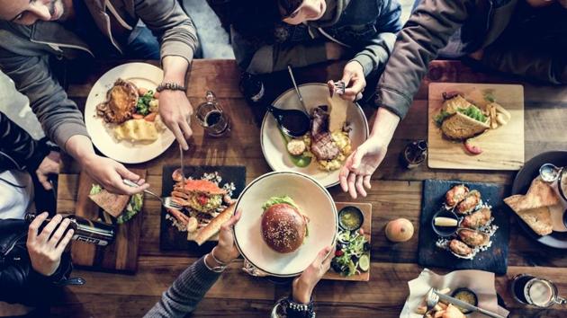 Louder environments increase stimulation and stress, making diners choose junk food like cheeseburgers and fries.(Shutterstock)