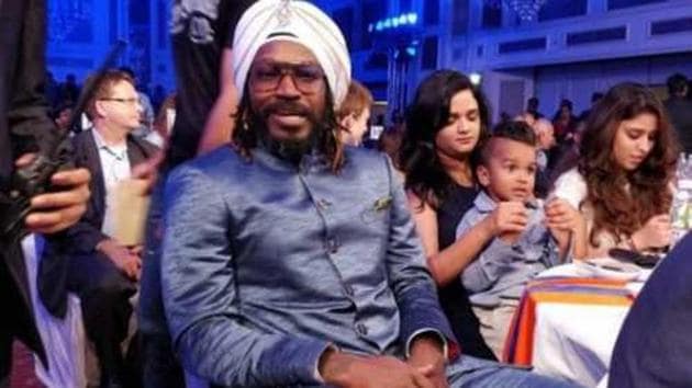 Chris Gayle was seen sharing the stage with Shikhar Dhawan and Rohit Sharma, leading the two Indian batsmen to perform a dance step at an award function.(HT Photo)