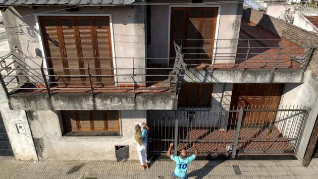 German tourists Oshin Gharibi and Lena Wagner leave a handwritten letter at the home where Messi grew up in La Bajada, Rosario, accidentally making the house alarm go off. The couple are students who saved for months to come all the way for a pilgrimage to their idol's native city but found no Messi statues, plaques or museums. (Natacha Pisarenko / AP)