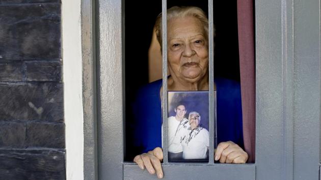 Lionel Messi's former neighbour Marta Rodriguez shows her autographed picture with the star in La Bajada. Messi is still strongly connected to Rosario. His accent and expressions are unchanged, even though he left the city as a teen 18 years ago. He returns often and last year, he married his childhood sweetheart in the city. (Natacha Pisarenko / AP)