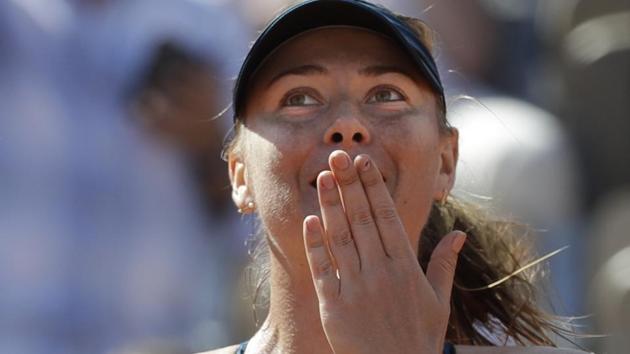 Maria Sharapova celebrates after winning her first round match against Richel Hogenkamp at the French Open on Tuesday.(AP)