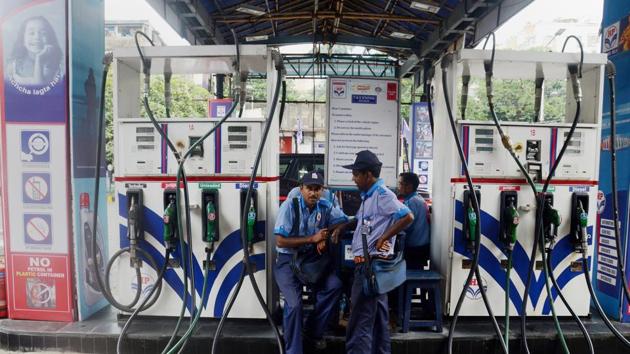 Employees at a petrol Pump in Kolkata on Saturday, as the fuel prices remain at record high level.(PTI Photo)