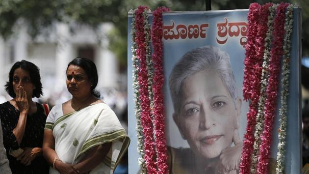 Mourners stand next to a portrait of Gauri Lankesh during the public viewing of her body in Bengaluru.(AP File Photo) Mourners stand next to a portrait of Gauri Lankesh during the public viewing of her body in Bengaluru.(AP File Photo)