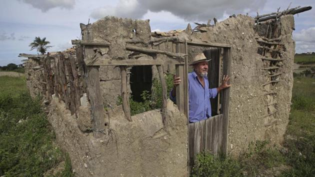 Eraldo dos Santos stands inside a replica of the birth home of his cousin, da Silva, in Garanhuns. “I believe this is a coup, that Lula should be freed and be our candidate. But we also must think about the future,” said dos Santos, while showing where da Silva used to live. “Lula is not immortal and we progressives need to put his ideas forward.” (Eraldo Peres / AP) 