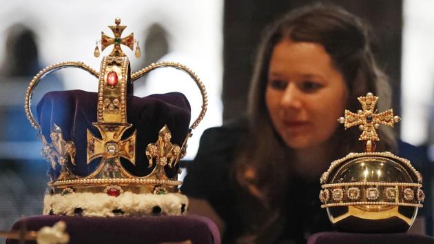 A woman looks at the St. Edward’s Crown and Orb, the centrepiece of the Crown Jewels of England, on display at the Galleries. The solid gold crown and orb named after Edward the Confessor have been used in all English coronations since the 13th century. The present version in use however, was made in 1661 for Charles II after the original was either sold or melted. (Frank Augustein / AP) A woman looks at the St. Edward’s Crown and Orb, the centrepiece of the Crown Jewels of England, on display at the Galleries. The solid gold crown and orb named after Edward the Confessor have been used in all English coronations since the 13th century. The present version in use however, was made in 1661 for Charles II after the original was either sold or melted. (Frank Augustein / AP)