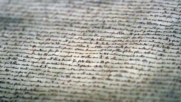 A section of the Magna Carta on display, part of an exhibition at the Westminster Abbey. The 800-year old document holds iconic status in British society as a symbol of constitutional safeguards against the powers of the ruler and is seen as an example of codified civil liberties. (Frank Augustein / AP) A section of the Magna Carta on display, part of an exhibition at the Westminster Abbey. The 800-year old document holds iconic status in British society as a symbol of constitutional safeguards against the powers of the ruler and is seen as an example of codified civil liberties. (Frank Augustein / AP)