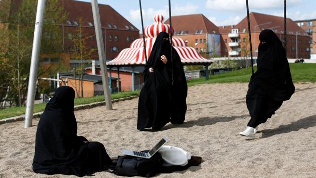 Zaynab (C) a Mjolnerparken resident, sits with her friends Amira and Sabrina in Superkilen. Some Mjolnerparken residents say the government drive could improve communities by reducing crime and boosting job prospects, but others fear it will simply entrench divisions by creating a parallel society where different rules apply. (Andrew Kelly / REUTERS) Zaynab (C) a Mjolnerparken resident, sits with her friends Amira and Sabrina in Superkilen. Some Mjolnerparken residents say the government drive could improve communities by reducing crime and boosting job prospects, but others fear it will simply entrench divisions by creating a parallel society where different rules apply. (Andrew Kelly / REUTERS)