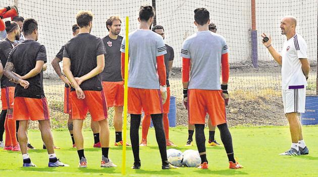 Players of FC Pune City along with former head coach Ranko Popovic (extreme right) during one of their practice sessions at Pune FC training pitch, Pirangut.(HT File Photo)