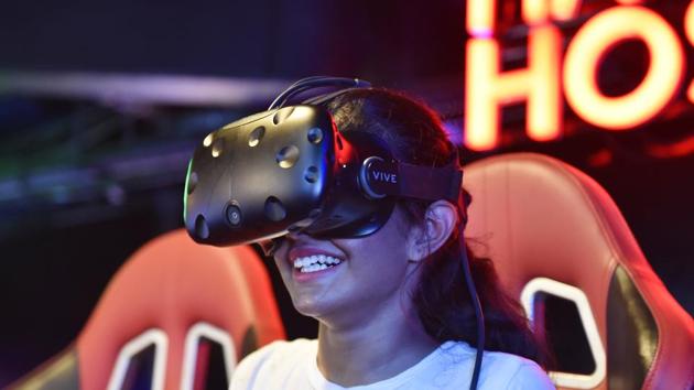 A visitors enjoys an immersive virtual reality experience at Smaaash in Cyberhub. This immersive indoor entertainment area is a one-of-a-kind oasis for leisure seeking individuals or entire workforces. Have your pick from cutting edge VR experiences, simulators or the more analog games on offer. (Sanjeev Verma / HT Photo)