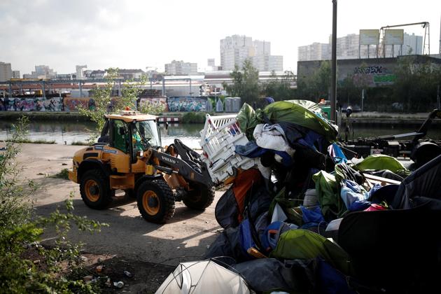 While they were being moved out, bulldozers ripped through the migrants’ tents. Two migrants drowned this month in canals along encampments and others have been injured amid rising tensions in the filthy, crowded camps, adding pressure on authorities to act. But the evacuation was delayed for months amid bickering over what to do with the settlers. (Benoit Tessier / REUTERS) While they were being moved out, bulldozers ripped through the migrants’ tents. Two migrants drowned this month in canals along encampments and others have been injured amid rising tensions in the filthy, crowded camps, adding pressure on authorities to act. But the evacuation was delayed for months amid bickering over what to do with the settlers. (Benoit Tessier / REUTERS)