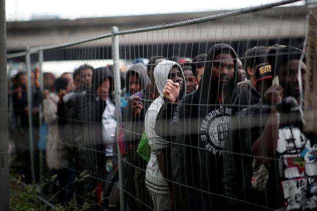 The encampment held at least 1,400 migrants, local officials have said, but 1,016 were cleared out, put in buses and taken to gymnasiums in the region. Several hundred migrants apparently fled before the evacuation. (Benoit Tessier / REUTERS) The encampment held at least 1,400 migrants, local officials have said, but 1,016 were cleared out, put in buses and taken to gymnasiums in the region. Several hundred migrants apparently fled before the evacuation. (Benoit Tessier / REUTERS)
