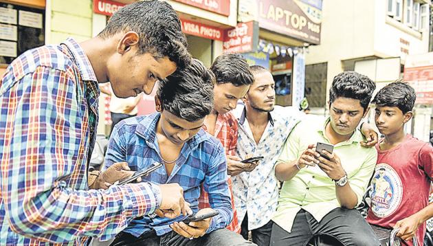 Students spent much of the early afternoon on Wednesday checking the HSC board exam results on their mobile phones, as is seen with this group on Bajirao road.(SANKET WANKHADE/HT PHOTO) Students spent much of the early afternoon on Wednesday checking the HSC board exam results on their mobile phones, as is seen with this group on Bajirao road.(SANKET WANKHADE/HT PHOTO)