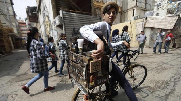 Dressed in an old straw hat and navy suspenders, Abo Tawila pedals around a southern district of Beirut. A rare sight in modern-day Lebanon, the young barber-on-a-bike is looking for his next customer. His real name is Mohammad Khaled Jahjah, but he prefers the name Abo Tawila -- “the Tall One” in Arabic. (Joseph Eid / AFP) Dressed in an old straw hat and navy suspenders, Abo Tawila pedals around a southern district of Beirut. A rare sight in modern-day Lebanon, the young barber-on-a-bike is looking for his next customer. His real name is Mohammad Khaled Jahjah, but he prefers the name Abo Tawila -- “the Tall One” in Arabic. (Joseph Eid / AFP)