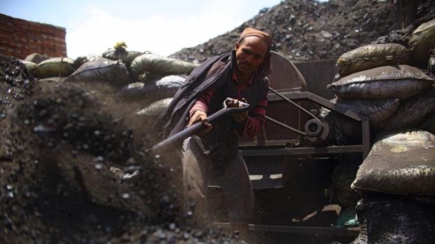 A worker shovels coal at a brick factory in Bhaktapur. There are more than 150,000 kilns in India, Bangladesh, Pakistan and Nepal, belching out thousands of tonnes of soot known as black carbon—a major air pollutant and the second largest contributor to global warming and changing weather patterns after carbon dioxide. South Asia has the highest such emissions in the world, according to a NASA study. (Gopen Rai / AFP) 