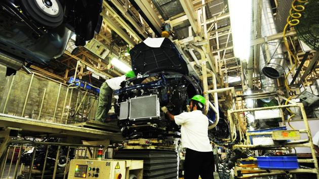 Maruti Suzuki Swift is assembled at the welding floor in 2011. Manufacturing and back-end support services have come to define the rise of Gurugram as the Millenium City. The ample office space Gurugram had to offer multinationals in the mid 1990s shaped its image in the minds of people. Glitzy malls and gated residences are also on offer now, but the BPO remains synonymous with the city. (Ramesh Pathania / Mint Archive)