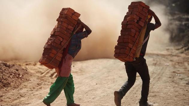 On the edge of Kathmandu, sweaty bare-footed workers hack away at the grey clay and haul heavy loads of bricks to and from cavernous kilns. Most live in shacks around the factories. As bonded labourers, the next generation is literally born into the industry with 16% of Nepal’s 200,000 kiln workers children according to Better Brick Nepal, which is campaigning for better conditions. (Gopen Rai / AFP) 