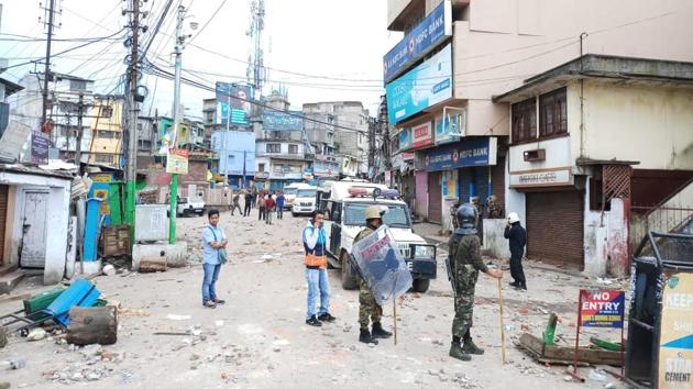Security personnel stand on vigil in Motphran in Shillong on Friday, a day after communal tension prevailed in the area.(HT PHOTO)