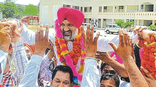 Winner Hardev Singh Ladi Sherowalia celebrating with supporters in Shahkot on Thursday.(Pardeep Pandit/HT)