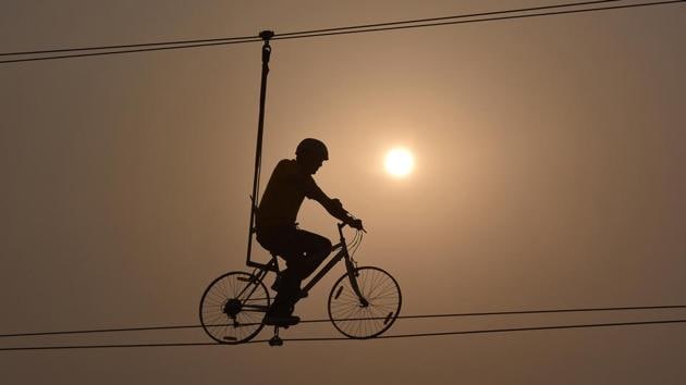 A person seen Sky Cycling at Frenzy Adventure Park, in Gurugram. Amusement parks, virtual reality, outdoor sports like paintballing and off-road adventure zones. Gurugram residents have a lot to keep them amused, with enough room for visitors. (Sanjeev Verma / HT Photo)