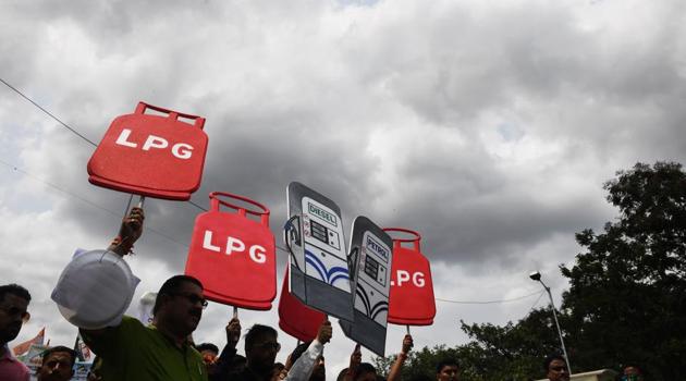 Activists of Trinamool Congress (TMC) party hold cut-out replicas of LPG cylinders and fuel dispensers during a protest against the Bharatiya Janata Party (BJP) lead central government for the steady hike in fuel prices, in Kolkata on May 29, 2018(AFP Photo) Activists of Trinamool Congress (TMC) party hold cut-out replicas of LPG cylinders and fuel dispensers during a protest against the Bharatiya Janata Party (BJP) lead central government for the steady hike in fuel prices, in Kolkata on May 29, 2018(AFP Photo)