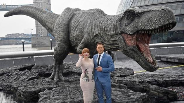 Cast members Chris Pratt and Bryce Dallas Howard pose in front of a model dinosaur during a photocall to promote the forthcoming film Jurassic World: Fallen Kingdom in London.(REUTERS) Cast members Chris Pratt and Bryce Dallas Howard pose in front of a model dinosaur during a photocall to promote the forthcoming film Jurassic World: Fallen Kingdom in London.(REUTERS)