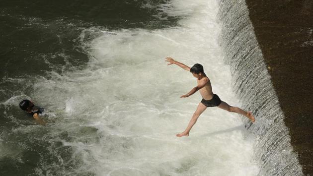 A boy jumps into a stream of water to beat the heat on a hot day on the outskirts of Srinagar, Jammu and Kashmir on May 31, 2018. (Waseem Andrabi / HT Photo) A boy jumps into a stream of water to beat the heat on a hot day on the outskirts of Srinagar, Jammu and Kashmir on May 31, 2018. (Waseem Andrabi / HT Photo)