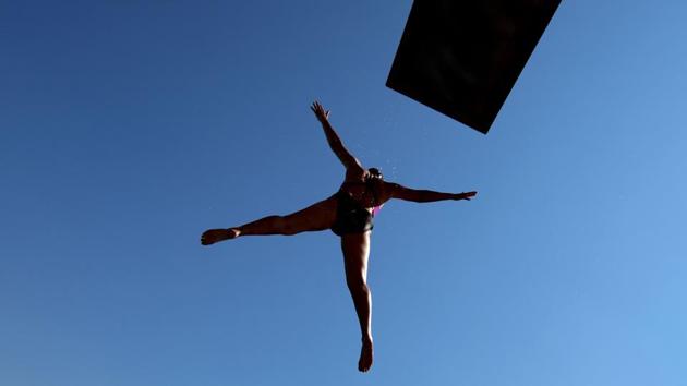 A lifeguard jumps into the water as she tests the new diving pool at the Freibad Kiebitzberge public open air swimming pool at Kleinmachnow near Potsdam, Germany on May 30, 2018. (Ralf Hirschberger / AFP) A lifeguard jumps into the water as she tests the new diving pool at the Freibad Kiebitzberge public open air swimming pool at Kleinmachnow near Potsdam, Germany on May 30, 2018. (Ralf Hirschberger / AFP)