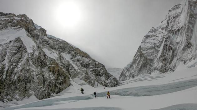 File photo of mountaineers walking near a camp of Mount Everest. (AFP photo) File photo of mountaineers walking near a camp of Mount Everest. (AFP photo)