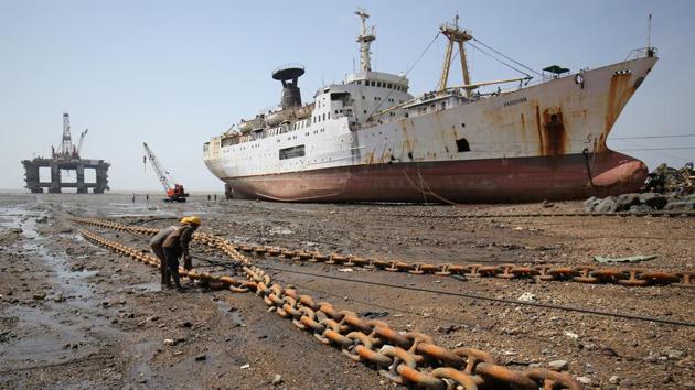 Workers pull a rope tied to a decommissioned oil rig to dismantle it at the Alang shipyard in Gujarat on May 29, 2018. (Amit Dave / REUTERS) Workers pull a rope tied to a decommissioned oil rig to dismantle it at the Alang shipyard in Gujarat on May 29, 2018. (Amit Dave / REUTERS)